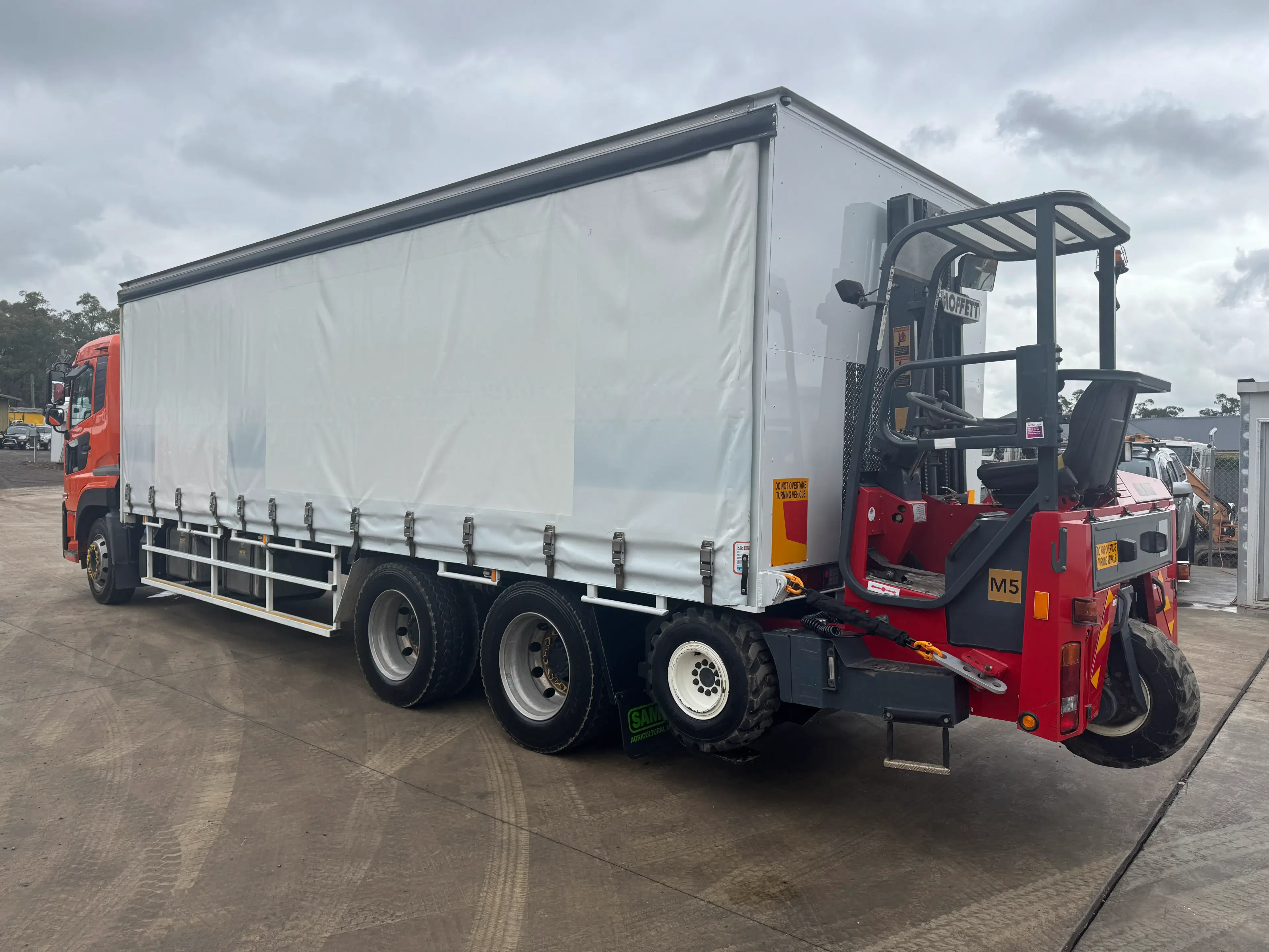 UD Quon truck with Moffett forklift