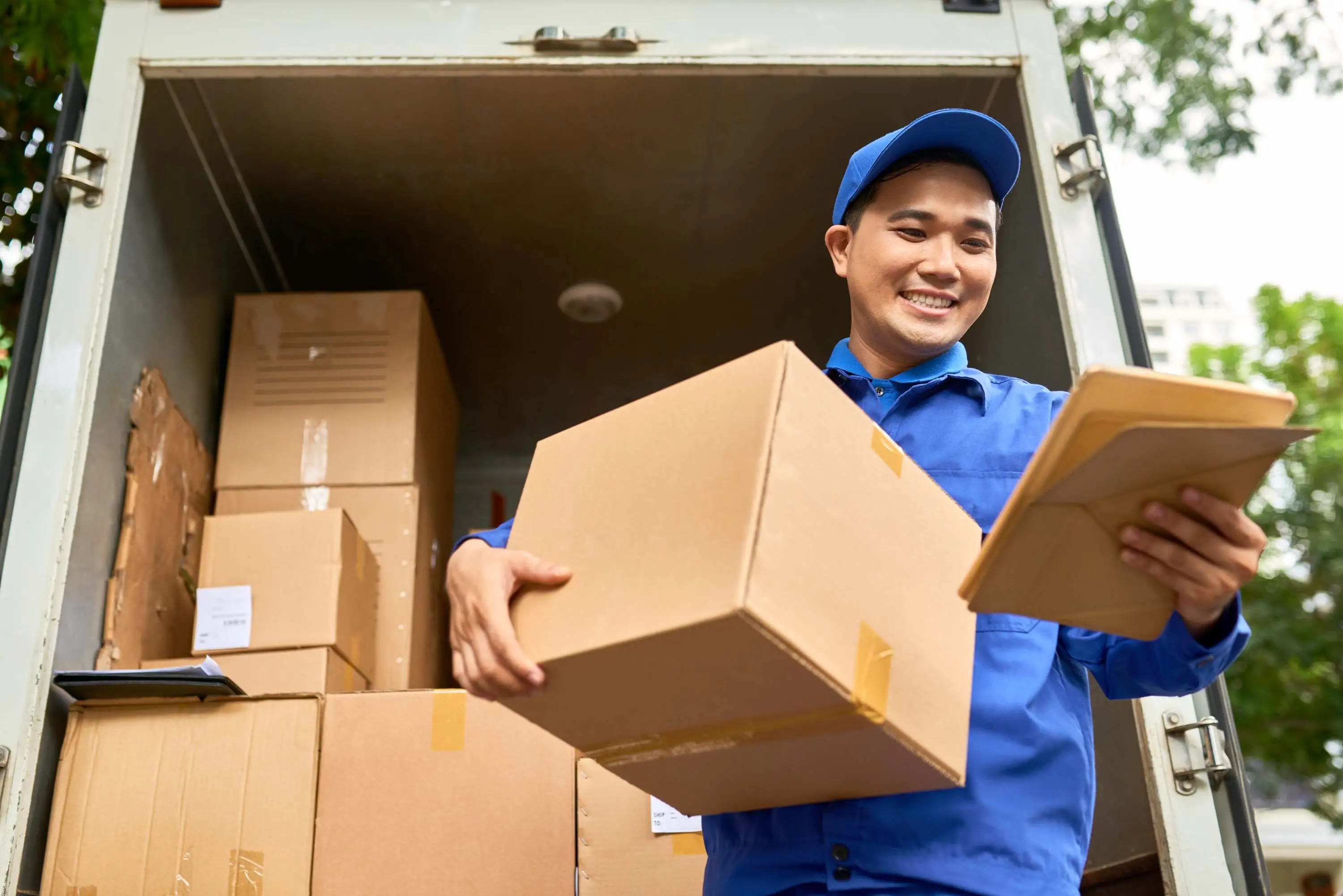 Courier holding a parcel and a clipboard